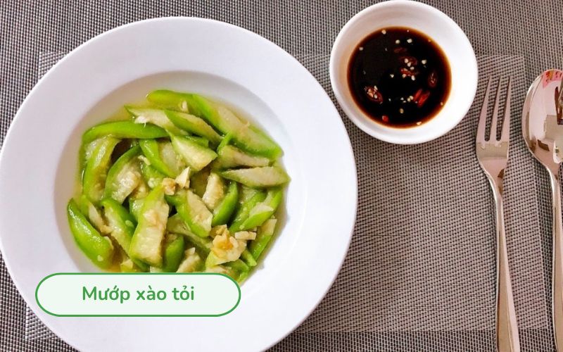 Mướp xào tỏi màu xanh tươi, mướp mềm bóng nhẹ, xen lẫn tỏi vàng thơm